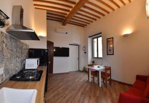 a kitchen and living room with a stove and a table at Il Garibaldino in Livorno