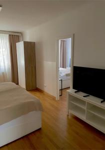 a bedroom with a bed and a flat screen tv at Apartment Wien Mitte in Vienna