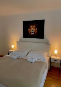 a bedroom with a bed with a lion picture on the wall at Apartment Wien Mitte in Vienna