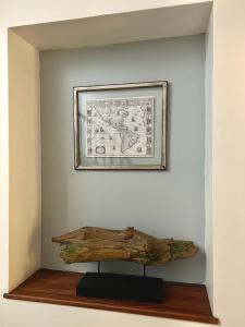 a picture hanging on a wall with a piece of drift wood at HOTEL BOUTIQUE CASA NOBLE SPA in Santiago