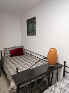 a room with a bed and a table with a couch at Lille en Provence in Valencia
