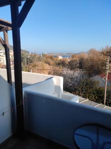 a view from the balcony of a house with a bathtub at Kea Island in Korissia