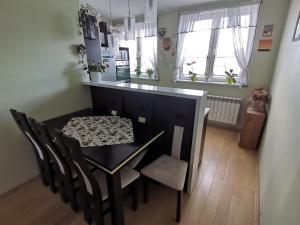 a dining room with a table and chairs in a room at Cztery kąty in Bielsko-Biala