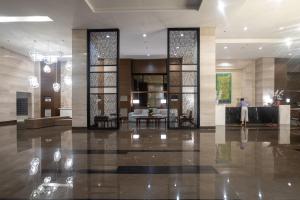 a lobby of a hotel with a table and chairs at The Radiance Manila Bay in Manila