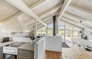 a kitchen with white appliances and a vaulted ceiling at Gorgeous Home In Jerup With Kitchen in Jerup
