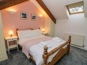 a bedroom with a large bed in a room at Clover Cottage in Kirkby Stephen