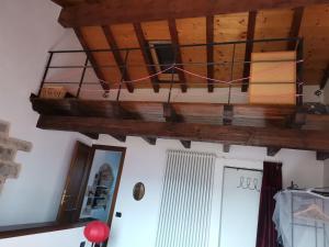 a room with a wooden ceiling with a chandelier at Cà Feddia in Bagnone