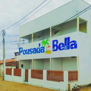 a building with a sign on the side of it at Pousada Ilha Bella in Galinhos