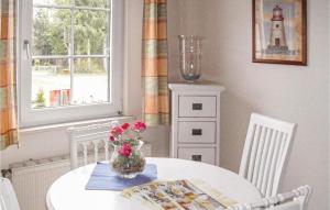 a dining room with a white table and a lighthouse at Apartment Faßberg Op-1745 in Oberohe