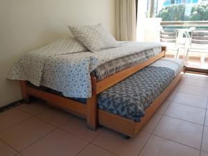 a bedroom with a bed with a pillow on it at Apart Hotel Sendero del Sol in La Serena