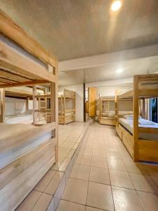 a large room with several bunk beds in it at El Gato Rojas Surf Hostel in Santa Teresa Beach