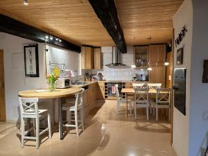 a kitchen with a table and chairs in it at Hadassa Apartments Saba / Jona in Uetendorf