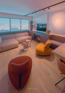 a living room with a couch and a fire place at Luxueus genieten aan zee: private jacuzzi en sauna in Knokke-Heist