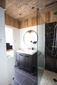a bathroom with a sink and a mirror at Ruim, lichtrijk appartement met terras in centrum in De Haan