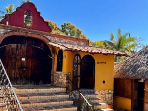 a building with stairs leading up to a door at Hotel Rancho Escondito in Puerto Escondido