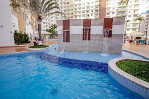 a swimming pool in the middle of a building at Riviera Park in Caldas Novas