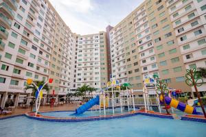 a pool with a water park in front of a hotel at Riviera Park in Caldas Novas