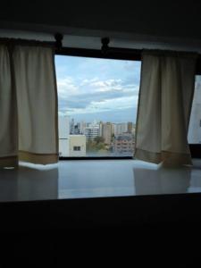 a window in a room with a view of a city at Ubicación ideal en Ciudad de Neuquén. in Neuquén