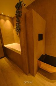 a bathroom with a tub with a plant on the wall at Luxueus genieten aan zee: private jacuzzi en sauna in Knokke-Heist