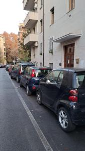 a row of parked cars parked next to a building at Lilia Charming house in Rome