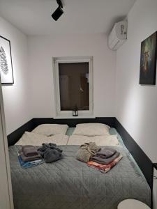 a bedroom with a bed with two towels on it at Włókna Inn Classic in Potrzanowo