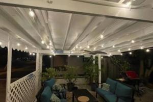 a screened in porch with chairs and a table at Seahorse Bungalow in St Pete Beach