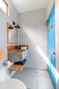 a bathroom with a sink and a toilet at Little Hawaii Avellanas in Playa Avellana