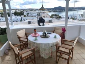 a table and chairs on a balcony with a view at Celia in Adamas