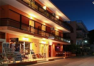 a building with a store in front of it at night at Astir Rooms in Poros