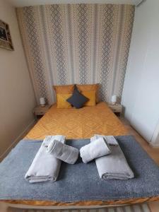 a bedroom with a bed with two pairs of socks at Au feu de Berque in Cherbourg en Cotentin