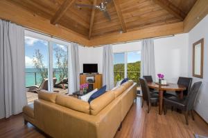 a living room with a couch and a table at Touch of Class home in Savannah Sound