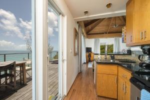 a kitchen with a view of the ocean at Touch of Class home in Savannah Sound