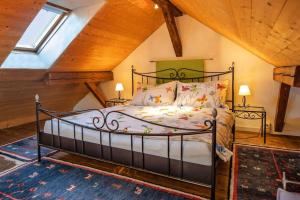 a bedroom with a metal bed in a attic at Hadassa Apartments Navah in Uetendorf