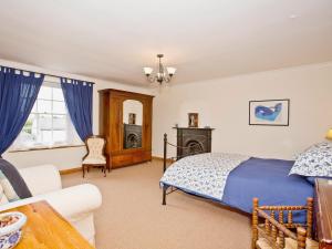 a bedroom with a bed and a living room at Cherry Tree Cottage in Bellerby