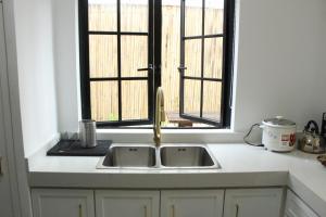 a kitchen with a sink and a window at Exclusive Luxury Modern Home near Robinson's Place in Manila