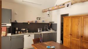 a kitchen with a counter and a table in it at La Grange Saint-Jacques in Bach +10 photos