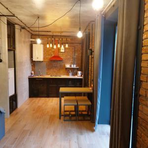 a kitchen with a table and a dining room at Loft city center in Poltava
