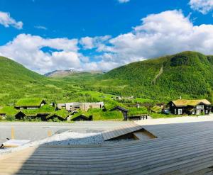 a view of a town with mountains in the background at Large and luxurious family cabin in Myrkdalen in Helgatun