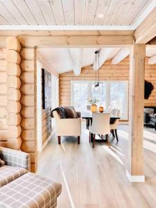 a living room with a table and a dining room at Large and luxurious family cabin in Myrkdalen in Helgatun