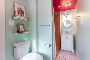 a bathroom with a toilet and a sink at Juleps And Lilies Germantown 1 Bedroom Apartment in Louisville