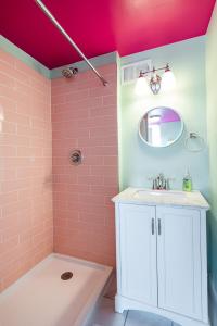 a bathroom with a sink and a pink ceiling at Juleps And Lilies Germantown 1 Bedroom Apartment in Louisville
