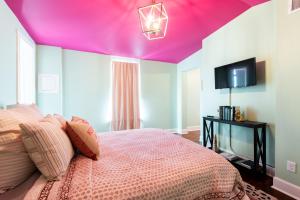 a bedroom with a purple ceiling and a bed at Juleps And Lilies Germantown 1 Bedroom Apartment in Louisville