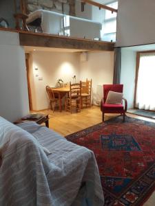 a bedroom with a bed and a table and chairs at holly cottage in Whitby