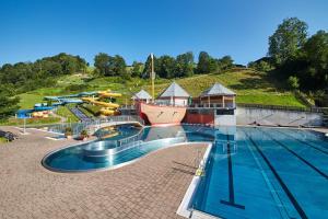 a water park with a slide and a swimming pool at Haus Kohlbründl in Saalbach-Hinterglemm
