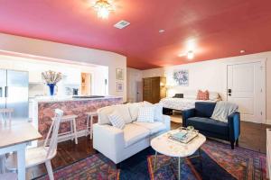 a living room with a couch and a table at Blush And Bashful Germantown Two Bedroom Apartment in Louisville