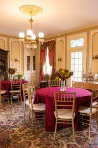 a dining room with tables and chairs with purple table cloth at The Hollinger House in Lancaster