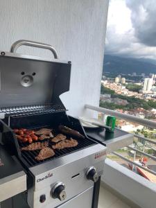 a grill on a balcony with food on it at Habitaciones vista azul campestre-diagonal a la Foscal in Floridablanca