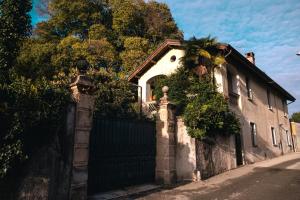 a house with a gate and a palm tree on it at Luxury apartment lake Lago Maggiore in Germignaga