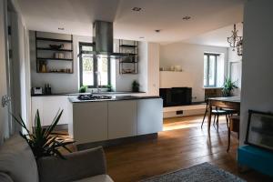 a living room with a kitchen with a stove at Luxury apartment lake Lago Maggiore in Germignaga