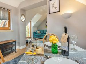 a dining room with a table with a bottle of wine at The Water Shed in Counthorpe